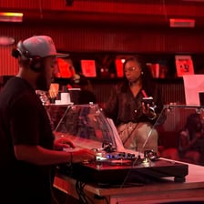 A DJ spinning records at a local club.