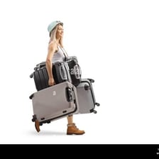 A person carrying a heavy suitcase with effort