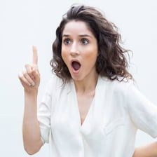 A person reacting with visible surprise and understanding.