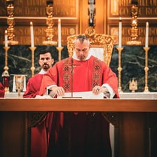 A deacon assisting during a church service.