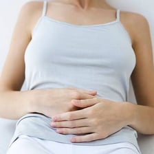 A person showing discomfort from nausea.