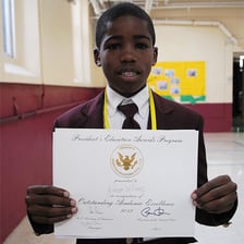 A student being recognized for exemplary achievement.
