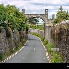 A narrow, lightly traveled road winding through the countryside.
