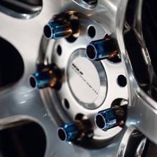 A lug nut fitted onto a vehicle wheel stud
