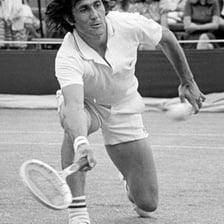 Ilie Năstase playing tennis.