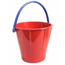 A small colorful pail beside a sandbox.