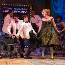 An actor appearing briefly on a theater stage.