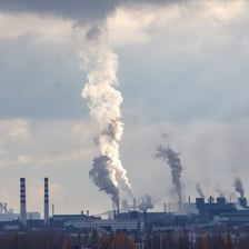 Dense fumes rising from an industrial facility.