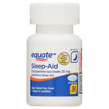 Sleep aid tablets beside a sleeping person