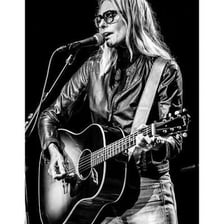 Singer-songwriter Aimee Mann performing onstage.