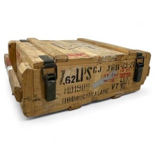 Military ammunition stored in crates beside cartridges
