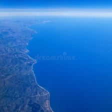 A broad deep-blue ocean expanse viewed from above.
