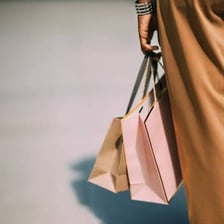 Person carrying multiple shopping bags during a spree