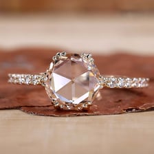 A diamond with the faceted, domed surface characteristic of a rose cut.