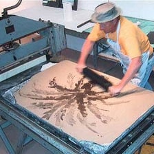 A lithographic art print beside a lithography stone