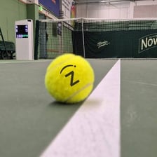 A tennis line judge signaling that a ball is out