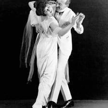 A couple performing an early twentieth-century ragtime-era dance.