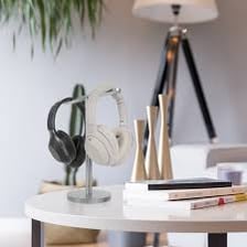 A pair of over-ear headphones resting on a desk.