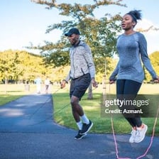 A person playfully skipping and leaping outdoors.