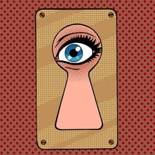 A person peeking through a keyhole.