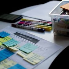 Planning documents and notes arranged on a desk.