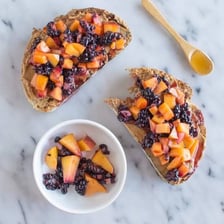 A slice of toast topped with glossy fruit jelly.