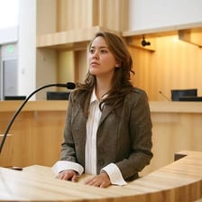 A witness giving evidence in a courtroom while under oath