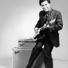 Freddy Fender performing with a guitar
