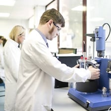 A scientist mixing ingredients while developing a product in a laboratory.