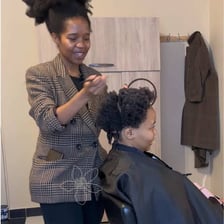 A hair stylist working on a client's hair.