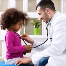A clinician performing a follow-up examination of a patient.