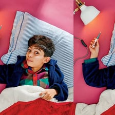 A person theatrically pretending to be ill in bed