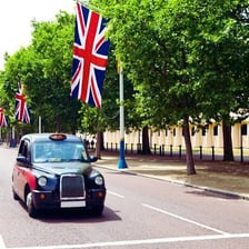 Black London taxi cab on a city street