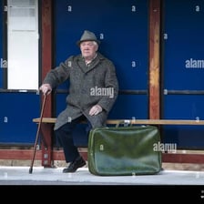 A person waiting at a bus stop.