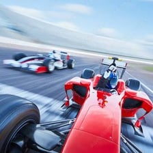A racing car crossing the finish line ahead of the others.