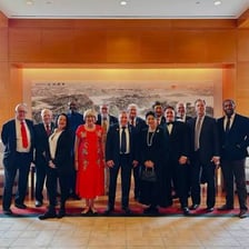 Representatives from two cities taking part in a sister-city partnership ceremony.