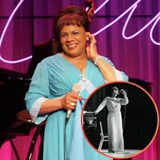 Ella Fitzgerald singing into a microphone during a jazz performance