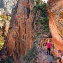 A narrow mountain trail beside a steep drop, illustrating a perilous route.