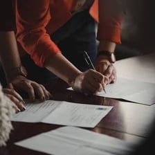A person signing a contract that creates an obligation.