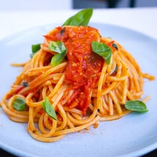 An Italian pasta dish covered in a rich tomato sauce.