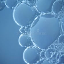 A close-up of thick white soap lather and bubbles