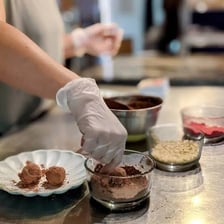 A chocolatier preparing handmade chocolate truffles.