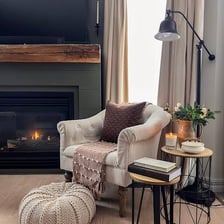A small comfortable corner with a chair and lamp for reading