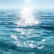 Sunlight glinting and shimmering across the surface of ocean water