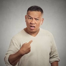 A person displaying an irritated expression during a conversation.