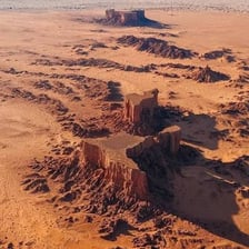 A flat-topped mesa rising above a surrounding landscape