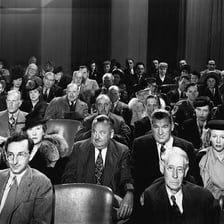 A comedian performing while the audience remains expressionless