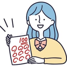 A student holding an exam marked with a perfect score