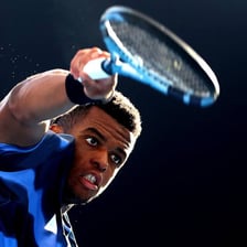 Tennis player striking a serve that becomes an ace