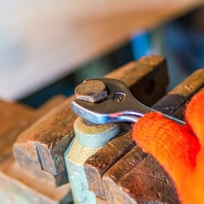 Hands tightening a screw to make a fastened part secure again.